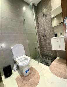 a bathroom with a toilet and a glass shower at Sabir Hadaj in Kenitra
