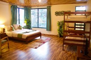 a bedroom with a bed and a bunk bed at Umda Hotel Montana in Nathia Gali