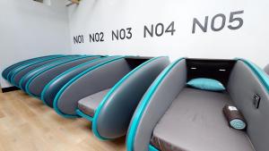 a row of surfboards lined up against a wall at Sleepover Terminal 3, Concourse B - formerly sleep 'n fly in Dubai