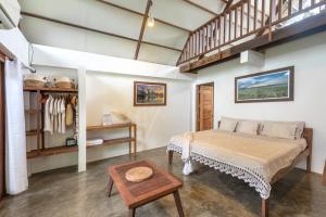 a bedroom with a bed and a table at Libertad Surf Villa in General Luna