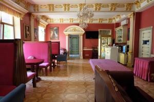a dining room with red walls and a chandelier at Hotel Lavilia in Kyiv