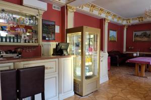 a bar in a restaurant with red walls at Hotel Lavilia in Kyiv