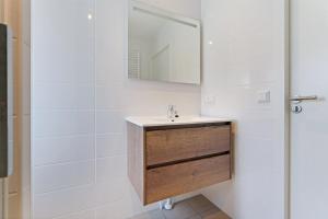 a bathroom with a sink and a mirror at Chalet Duynhof 8 - Ouddorp in Oudeland +18 photos