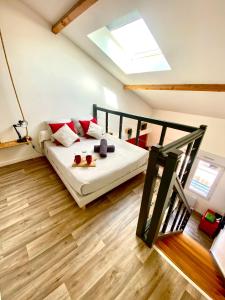 een slaapkamer met een bed met rode kussens erop bij Duplex industriel - Centre ville Parking privé WIFI in Angers