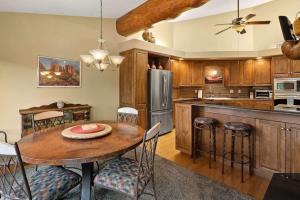 a kitchen with a wooden table and a dining room at Spacious Sedona Splendor with Community Spa & Pool in Sedona