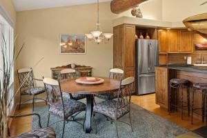 a kitchen with a table and chairs and a refrigerator at Spacious Sedona Splendor with Community Spa & Pool in Sedona