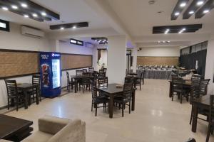 a dining room with tables and chairs and a table set up at Xefan Hotels in Karachi