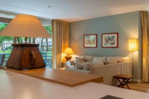 a living room with a couch and a table at Hello Zeeland - Appartement Park loverendale 25 in Domburg