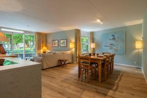 a kitchen and living room with a table and chairs at Hello Zeeland - Appartement Park loverendale 25 in Domburg