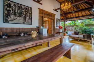 a living room with a large wooden table at Imagine Bali in Ubud