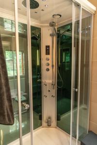 a shower with glass doors in a bathroom at Chalet Fuut in Erm