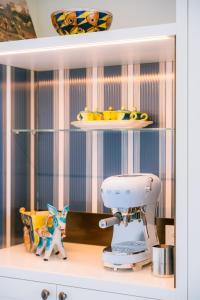 a kitchen counter with a sewing machine on a shelf at Residenza Dea Amalfi in Amalfi +15 photos