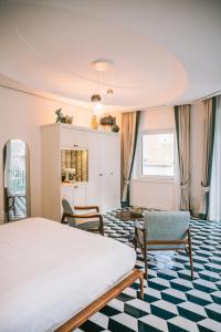 a bedroom with a bed and a table and chairs at Residenza Dea Amalfi in Amalfi