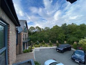a car parked in a parking lot next to a building at 4 Bedroom House in Milton Keynes in Milton Keynes