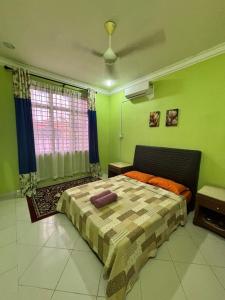 Ένα ή περισσότερα κρεβάτια σε δωμάτιο στο AF Homestay 1 Jalan Guchil Bayam