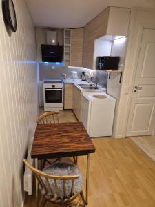 a small kitchen with a table and a sink at Overnatting Kjøllefjord, Hybelleilighet med kjøkkenkrok og eget bad in Kjøllefjord +5 photos