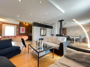 a living room with a couch and a pool table at Les hauts de Merfy maison 5 chambres avec piscine 