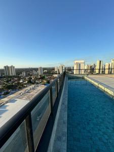a swimming pool on the roof of a building at Studio Cuiabá in Cuiabá
