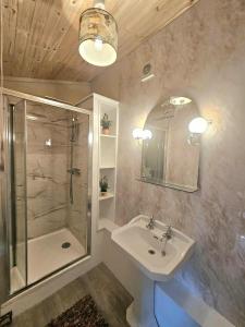 a bathroom with a sink and a shower at Bluebell Cottage At Lurley Manor in Washfield +41 photos