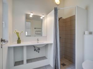 a bathroom with a sink and a shower at Holiday Home Lova - 600m from the sea by Interhome in Blåvand +29 photos