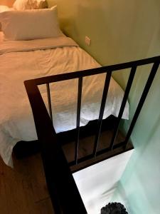 a bedroom with a bed with a black frame at Village 40 Phuket Old Town in Phuket