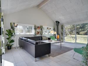 a living room with a couch and a table at Holiday Home Lova - 600m from the sea by Interhome in Blåvand