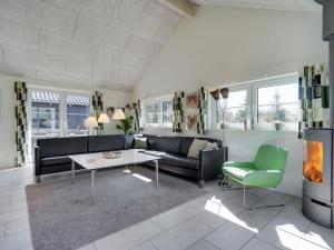 a living room with a couch and a table at Holiday Home Lova - 600m from the sea by Interhome in Blåvand