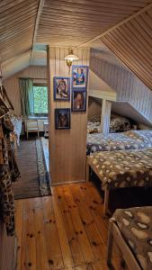 a bedroom with two beds and pictures on the wall at Ranczo Przyłęk 