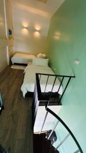 a room with two beds and a glass table at Village 40 Phuket Old Town in Phuket