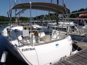 a white boat is docked at a dock at Zážitkové ubytování na vodě, Bavaria 34 in Frymburk