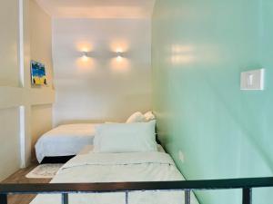 a small room with two beds and a table at Village 40 Phuket Old Town in Phuket