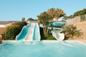 a water slide in a swimming pool at Slow Village Pornic in La Plaine-sur-Mer