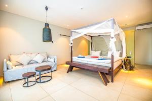 a living room with a bed and a couch at Kalimba Beach Resort in Kotu +37 photos