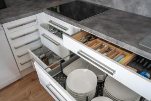 a kitchen with white cabinets and a sink at Cozy Comfort in Aerzen +9 photos