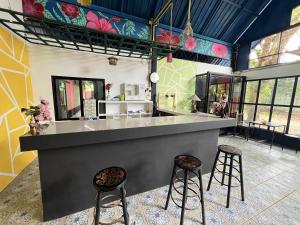 a bar in a room with two stools at The love shack atChaba in Ko Lanta
