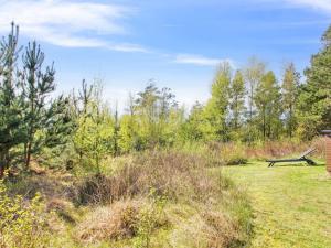 a park bench in the middle of a field at Holiday Home Efimija - 1-4km from the sea by Interhome in Mølby