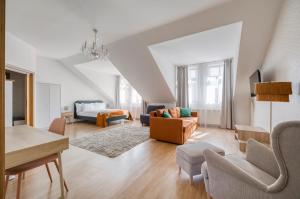 a living room with a couch and a table at Anmut by Revelton in Karlovy Vary