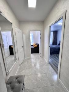 a hallway with two mirrors and a room with a bed at New Apart in the city center Ivano-Frankivsk Vysochana 18 street in Ivano-Frankivsʼk
