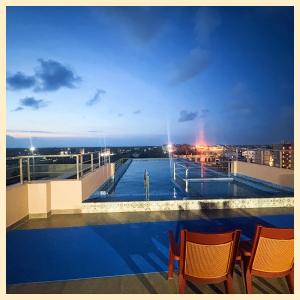 a swimming pool on the roof of a building at Sea Beach Hotel S#K#S Near Jagannath Temple# Restaurant - Swimming Pool - Spa With Parking Facilities All Luxuary Room and Fully Air Conditioned With Attached Balcony- Top Rated Hotel in Puri