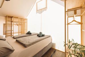 a bedroom with two beds and a large window at Glamping Resort Olive and Sea in Bibinje +61 photos