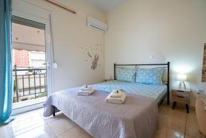 a bedroom with a bed with towels on it at N Ionia Essence - Couples Retreat by ΜΡS in Athens