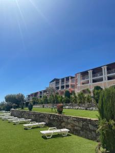 a row of lounge chairs on the grass in front of a building at Paradise Azur in Saint-Raphaël