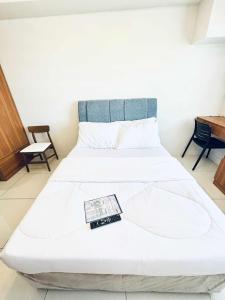 a bedroom with a bed with a remote control on it at Anchors Horizons in Cebu City