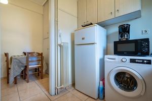 a kitchen with a white refrigerator and a washing machine at N Ionia Essence - Couples Retreat by ΜΡS in Athens