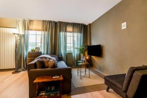 a living room with a couch and a tv at Wieler Wellness Huuske with private sauna in Spaubeek