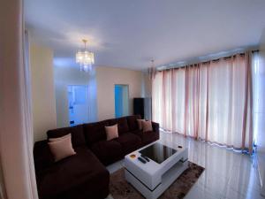 a living room with a couch and a coffee table at Cozy Up on 5th in Harare
