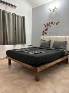 a bedroom with a bed with a black blanket at M R Holidays Apartments in Arpora +11 photos