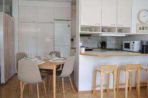 a kitchen and dining room with a table and chairs at Arctic Sauna Suite Rovaniemi in Rovaniemi