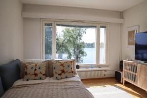 a bedroom with a bed and a large window at Arctic Sauna Suite Rovaniemi in Rovaniemi