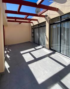 a patio of a house with a roof at Cozy Up on 5th in Harare